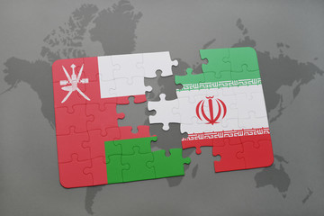 puzzle with the national flag of oman and iran on a world map background.