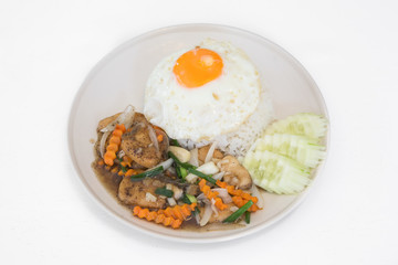 Rice with fried beef and oyster sauce on white wooden table
