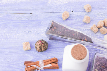 dry tea leaves cinnamon and on wooden background