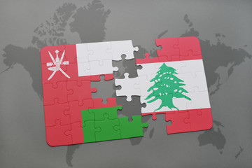 puzzle with the national flag of oman and lebanon on a world map background.