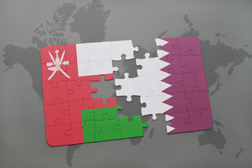 puzzle with the national flag of oman and qatar on a world map background.