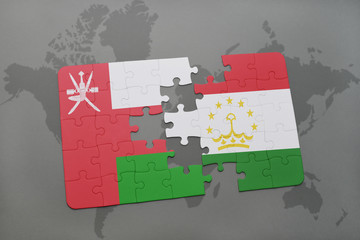 puzzle with the national flag of oman and tajikistan on a world map background.