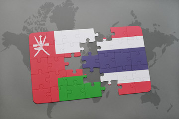 puzzle with the national flag of oman and thailand on a world map background.