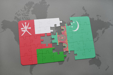 puzzle with the national flag of oman and turkmenistan on a world map background.