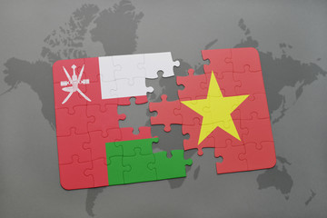 puzzle with the national flag of oman and vietnam on a world map background.