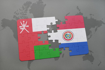 puzzle with the national flag of oman and paraguay on a world map background.
