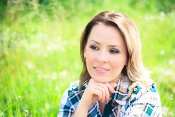 Fototapeta premium Portrait of a beautiful attractive woman outdoors in the summer