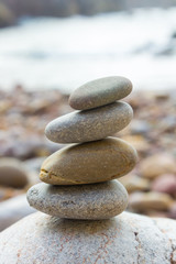 Fototapeta na wymiar Colored stones set in balance on a beach