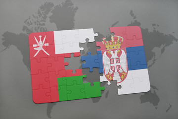 puzzle with the national flag of oman and serbia on a world map background.