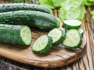 Cucumbers on the wooden table.