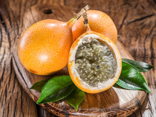 Granadilla fruits on the wooden table.