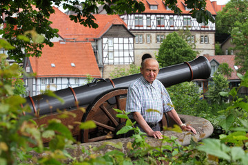 Elderly man in a historic german town - obrazy, fototapety, plakaty