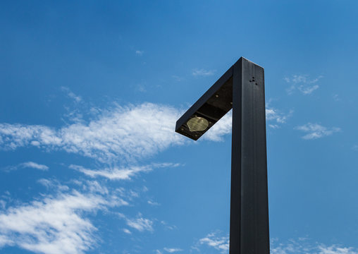 Modern street lighting against blue sky - bottom view