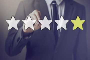 Businessman drawing one star in the air - indicates disatisfaction, unhappy, bad performance in...