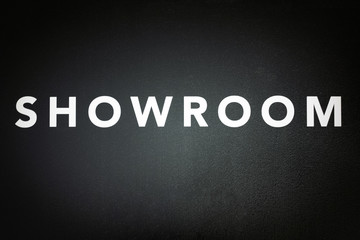 showroom , white text on black door