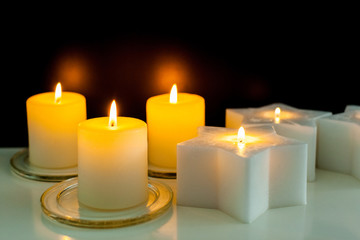 closeup to burning candles in darkness