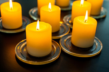 closeup to burning candles in darkness