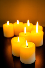 closeup to burning candles in darkness