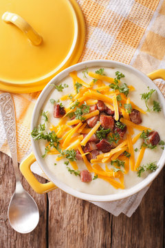 Tasty thick potato soup with bacon and cheddar cheese. Vertical top view
