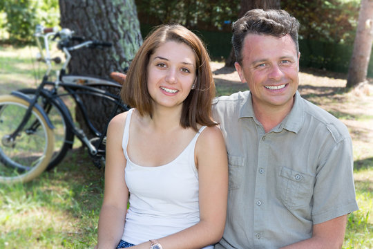 Young couple on a bike ride on a sunny day in the forest