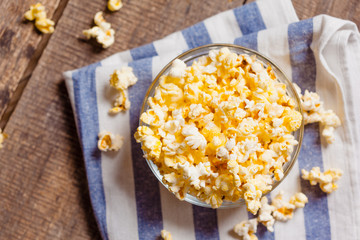 A bowl of popcorn on tablecloth