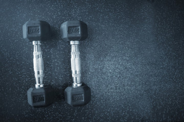 Top view of dumbbell exercise weights on the floor at fitness gym with copy space