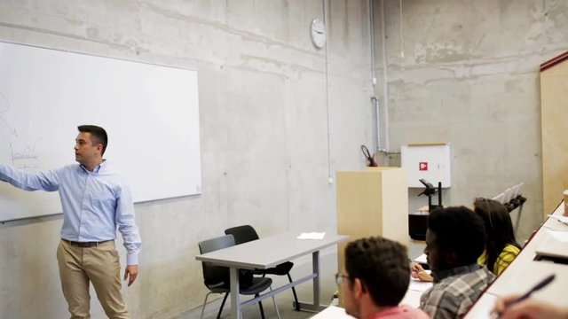 students and teacher at white board on lecture