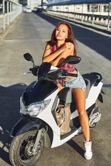 Foto op Plexiglas Portrait of stylish girl on scooter - outdoor fashion portrait © paultarasenko