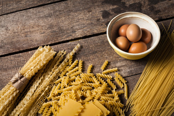 Pasta spaghetti with egg on old wooden background