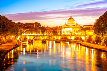 Rome skyline at evening with San Pietro basilica illuminated by city lights of Rome, Italy.