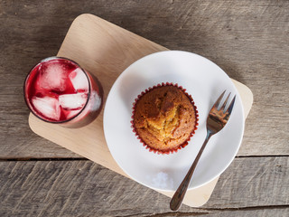 Flat lay banana cup cake and grape juice