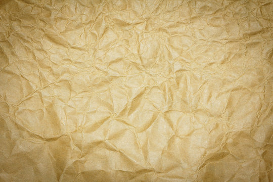 Closeup brown recycled crumpled paper texture or brown recycled crumpled paper background for design with copy space for text or image. Dark edged.