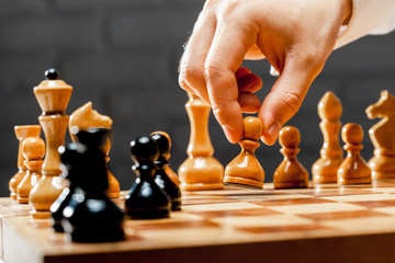 Hand of businessman playing chess