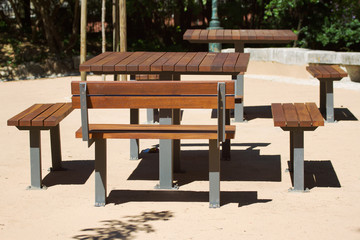 wooden table and bench in the city park