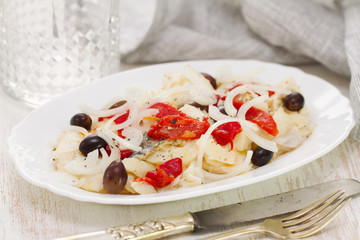fish with red pepper and olives on dish