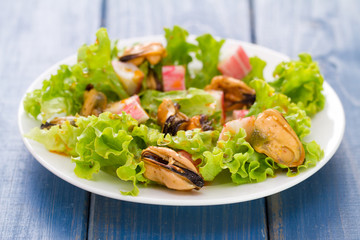 seafood salad on white dish on blue background