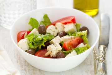 salad cheese with vegetables in white bowl