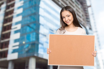 Young dark hair woman keeping cork board