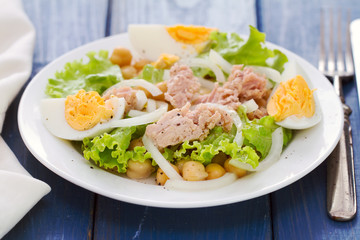 salad chickpeas with tuna and egg on white dish