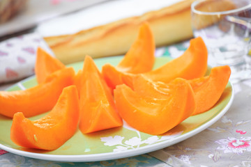 delicious Cantaloupe melon slices on the plate on table