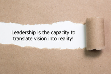 The quote "Leadership is the capacity to translate vision into reality" appearing behind torn paper