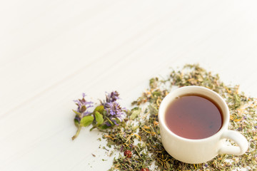 Cup of tea on table with herbs