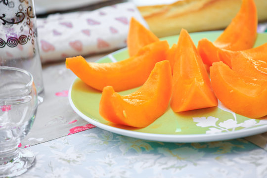 delicious Cantaloupe melon slices on the plate on table