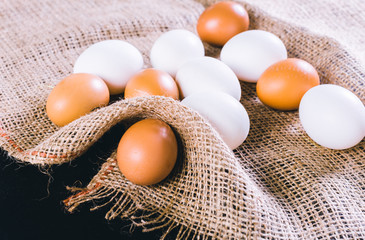 Eggs on tablecloth over black background