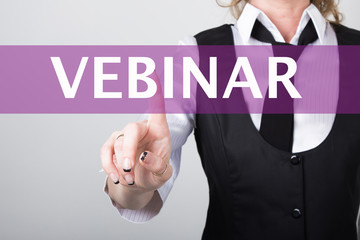 vebinar written in search bar on virtual screen. Internet technologies in business and home. woman in business suit and tie, presses a finger on a virtual screen