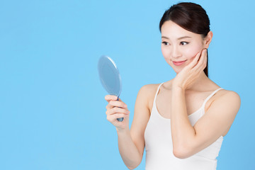 attractive asian woman isolated on blue background