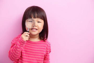 little girl holding magnifying