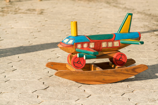 colorful of wood toy ; rocking horse airplane on concrete floor - copy space