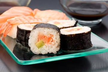 sushi with various bowl of sauce in  tray
