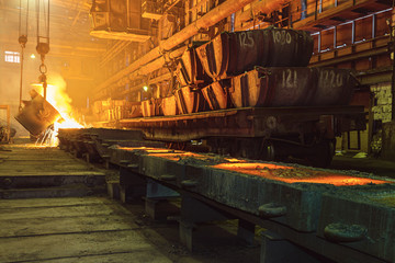 Ladle the hot metal at the metallurgical plant.